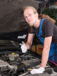 auto mechanic working on a car engine