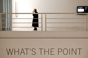 A photograph of a mural on a wall that reads: “What’s the Point?”