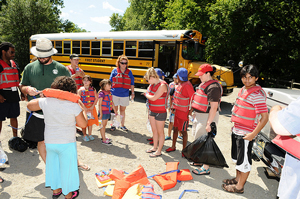 A photograph of a group of camp kids about to go canoeing.