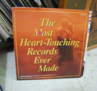 A photograph of a vinyl record cover titled “The Most Heart-Touching Records Ever Made.”