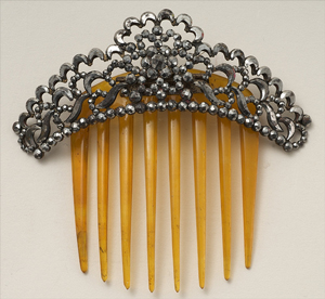 A photograph of an antique/decorative woman’s hair comb