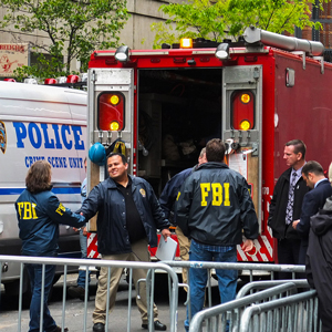 A photograph of a police and FBI crime scene unit.