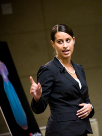 A photograph of a female attorney presenting an argument.