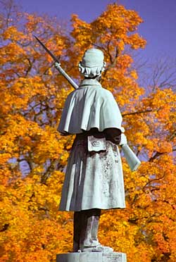 Sculpture of Civil War soldier surrounded by Autumn leaves