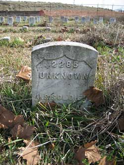 Image of a Cementery headstone with an inscription that reads “Unknown”