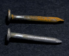 picture of two nails with one nail rusted 