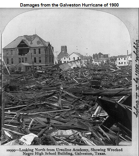 Image of piles of debris and a damaged school building in the background
