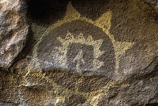 Image of a rock that is containing an American-Indian graphic of a sun