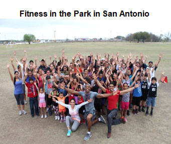 image of a group of people standing with their hands up