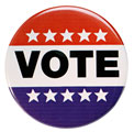 A red, white, and blue campaign button that has white stars and reads VOTE in black letters.