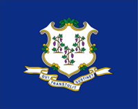 The flag of the state of Connecticut, a medium blue flag with a coat of arms that has three nutmeg trees, and the motto Qui Transtulit Sustinet on the bottom.