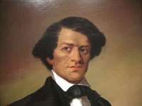 A portrait of a man with his hair parted into a sharp triangle wearing a black coat, white dress shirt and closely knotted string tie.