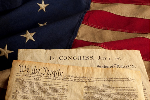 Image of the Constitution and Declaration of Independence on top of a US flag.