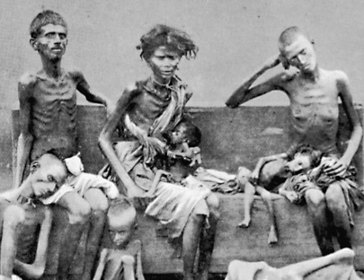 Image of an Indian Family who are emaciated; their bones are visible through their skin. Seated are:  an adult male; a mother holding a baby; an adult male with a small child leaning on him. On the floor an adolescent male leans on the adult male a smaller male sits nearby.