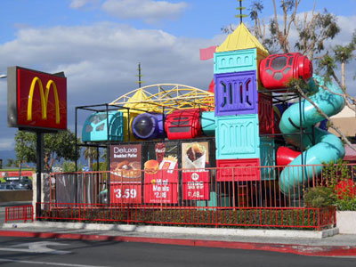 Image of a playland of a McDonald's restaurant. The golden arches sign is seen out front. 