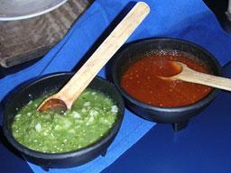 Image of a bowl of red salsa and a bowl of verde (green) sauce