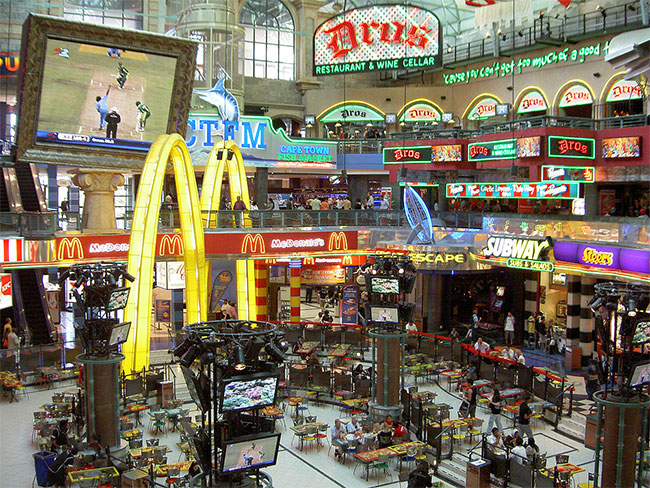 Image of a three story food court with several restaurants visible