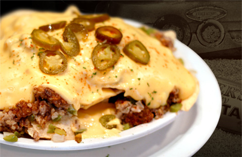 image of a bowl of nachos topped with cheese and jalapenos