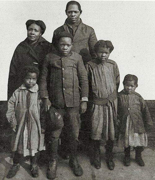 Image of an African-American family (a mother and father and two young boys and two young girls.
