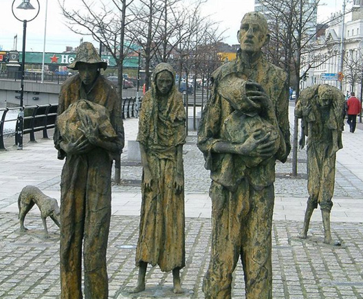 Image of four sculptures of the famine memorial in Dublin.