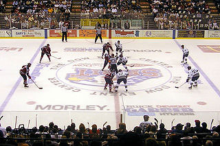Image of a game of ice hockey being played inside a rink