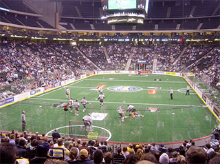 Image of a game of lacrosse being played inside a stadium