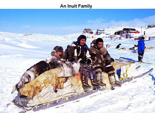 Image of an Inuit family sitting on a sleigh stacked with animal skins and other items from a hunt