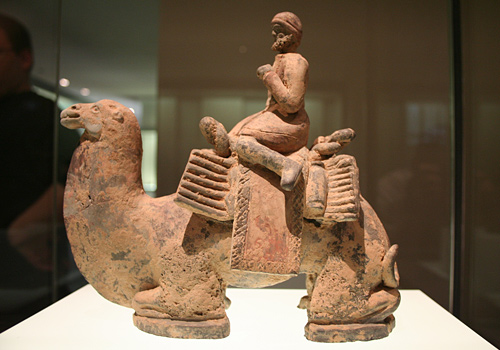 Image of an ancient Chinese sculpture of a bearded 'westerner' on a camel.