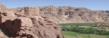 Image of mountains in Afghanistan, a green valley sits