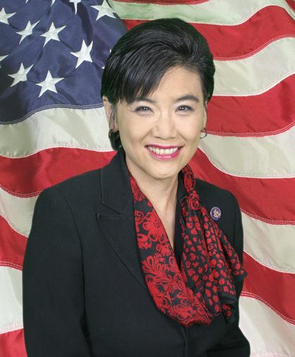 Image of Judy Chu with a backdrop of a flowing American flag.