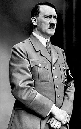 A photograph of Adolf Hitler in uniform. He is a middle aged man with a cropped moustache.