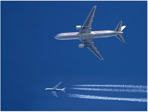 photo: 2 passenger jets in flight side by side but a great distance apart from each other