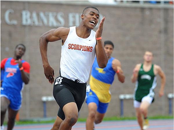 4 young men sprinting.