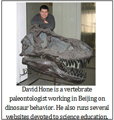 Image is of David Hone posing with a dinosaur skull