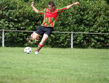 Image shows a boy playing soccer