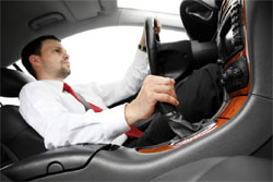 Image is of a man driving a car