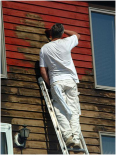 man painting a house