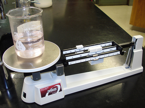 Liquid in a beaker. The beaker is sitting on a triple beam balance.