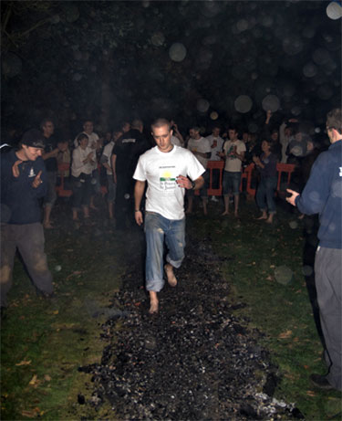 man walking across coals