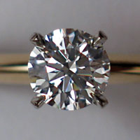 Photo of a four-pronged diamond taken up close to show the many prisms