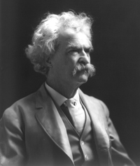 A photograph portrait of Mark Twain in his later years. He is wearing a suit and vest typical of the late 19th century.