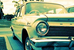 A photograph of an old station wagon in a driveway