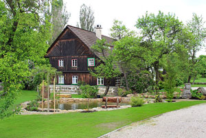 A photograph of a house with a rough wood exterior.