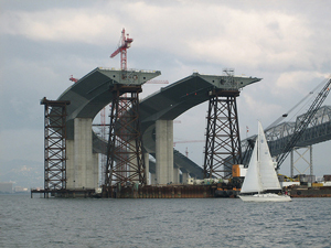 A photograph of two identical bridges being built over a body of water
