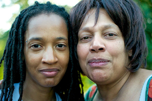 A photograph portrait of a mother and daughter cheek to cheek