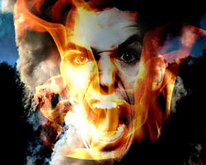 A photograph of a man screaming behind a wall of flames.