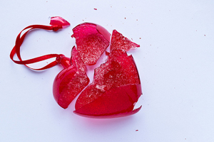 A photograph of a broken glass heart.