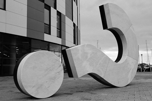 Photo of a huge question mark sculpture lying on its side