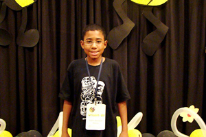 A photograph of a young man competing in a spelling bee