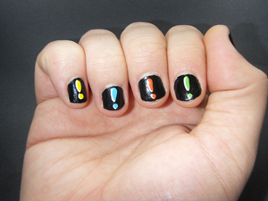 A photograph of a person's fingers with exclamation points painted on them.